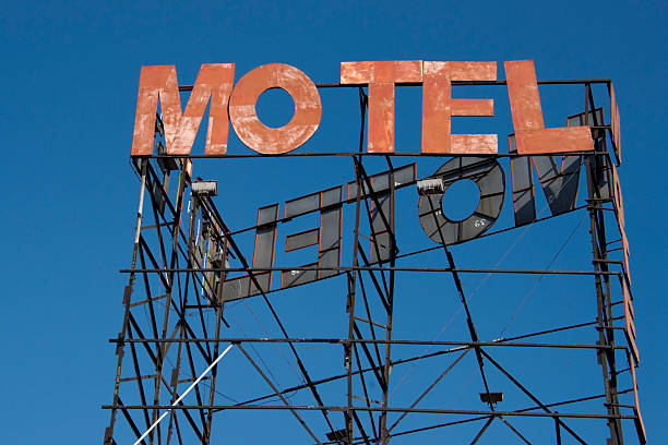 istock motel rusted sign on blue sky background 539016765