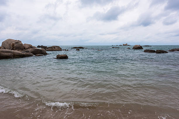 Free Stock Photo of Waterbody Surrounded by Rocks Under Cloudy Sky ...