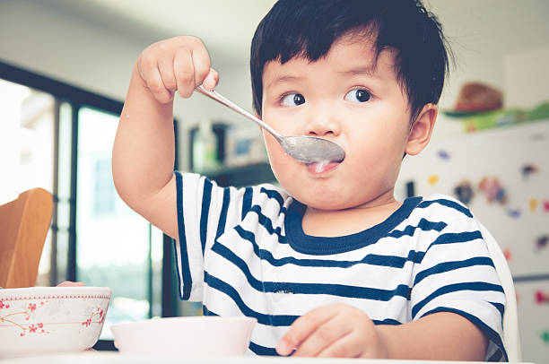 istock Asian toddler boy eating on high chair 539017790