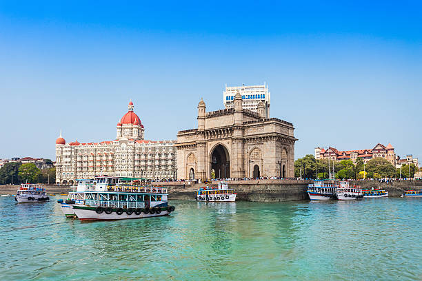 Taj Mahal Hotel and Gateway of India The Gateway of India and boats as seen from the Mumbai Harbour in Mumbai, India mahal stock pictures, royalty-free photos & images