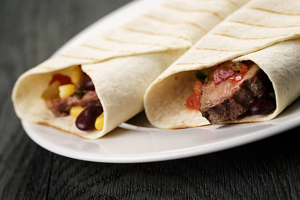 istock burritos with beef steak, corn, black beans and salsa sauce 539019048