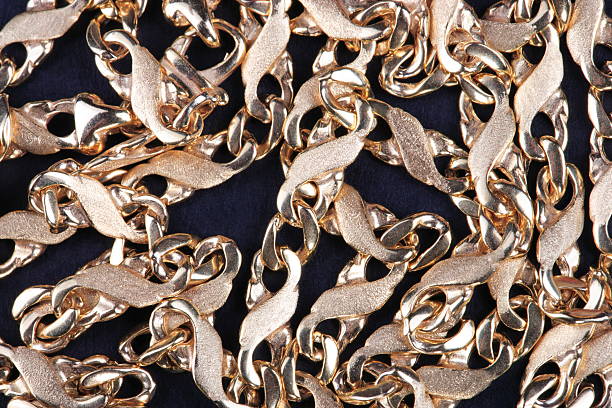 istock yellow Gold Chain on black fabric 539021300