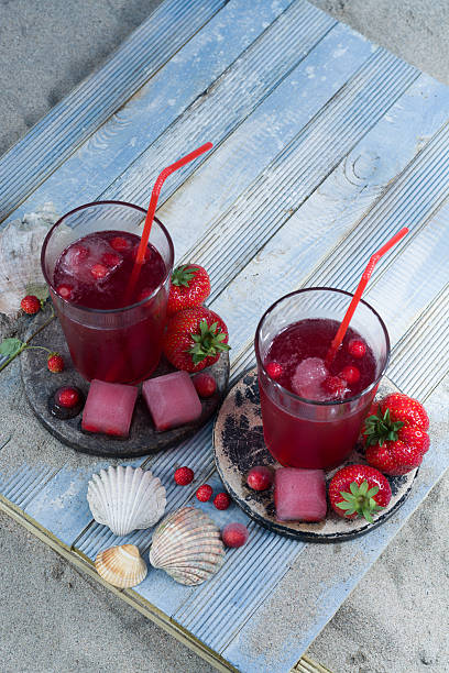 istock Freshly pressed juice mix with ice cubes on the beach 539022958