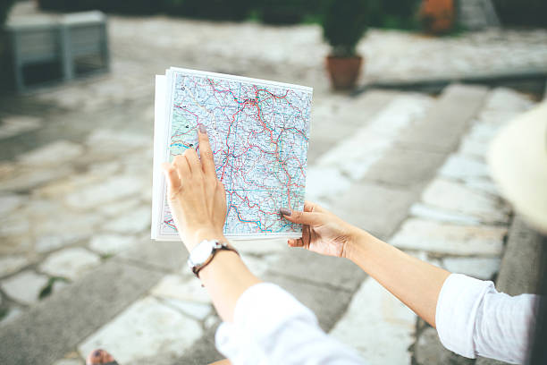 istock woman traveler holding a map 539024198