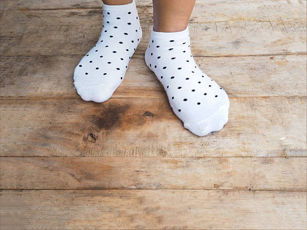istock feet wearing white polka dot socks 539025642