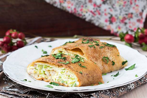 Roll from pancakes with zucchini, ham, cheese, creamy taste stock photo