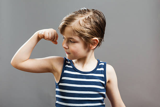 istock Little Sportive Tough Boy, Showing his Muscles 539026852