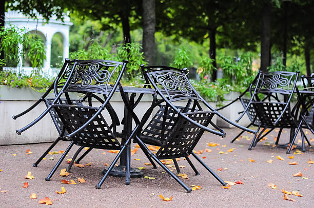 istock Slanted chairs stand around table in street cafe 539027197