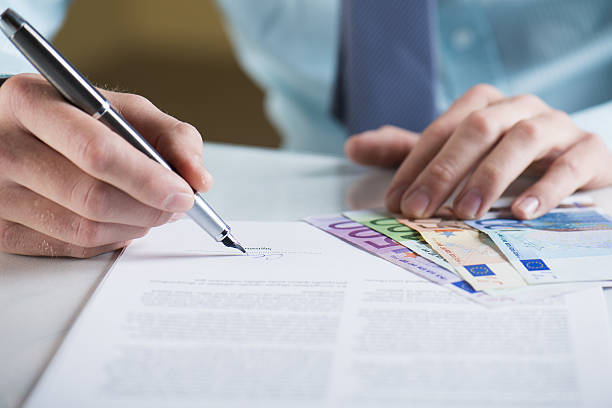 Businessman is signing a contract, business contract details Businessman is signing a contract, business contract details regler stock pictures, royalty-free photos & images