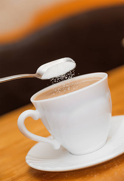 istock pour sugar to milk coffee of classical white cup 539027865