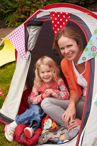 Mather And Daughter Enjoying Camping Holiday On Campsite