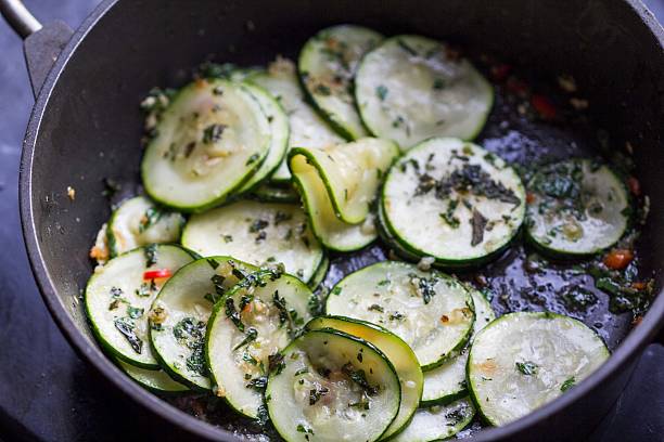 istock Thin slices of zucchini fried with herbs and chilli 539039523