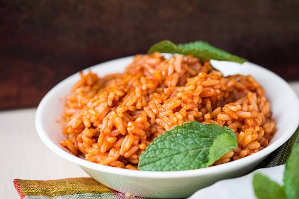 Red rice, risotto with tomatoes, easy vegetarian dish stock photo