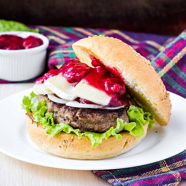Burger, hamburger with meat, cheese brie, camembert, berry stock photo