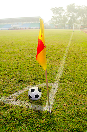 Corner flag with ball on a soccer field