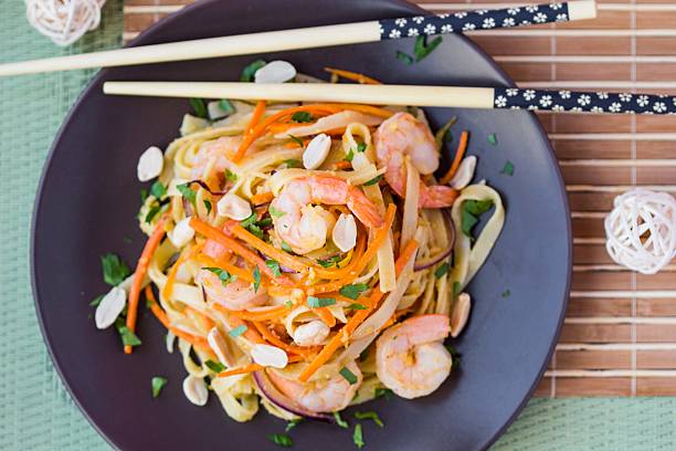 istock Asian noodles with shrimp, vegetables, carrots, peanuts, onions 539041369