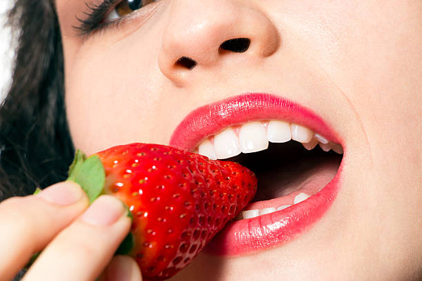 istock Sexy woman mouth biting strawberry 539042963