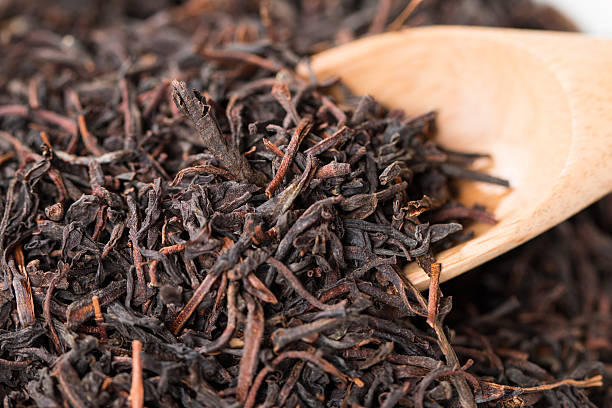 istock Dry tea leaves in wooden spoons 539043053