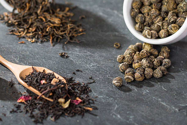 istock Dry tea leaves in wooden spoons 539043057