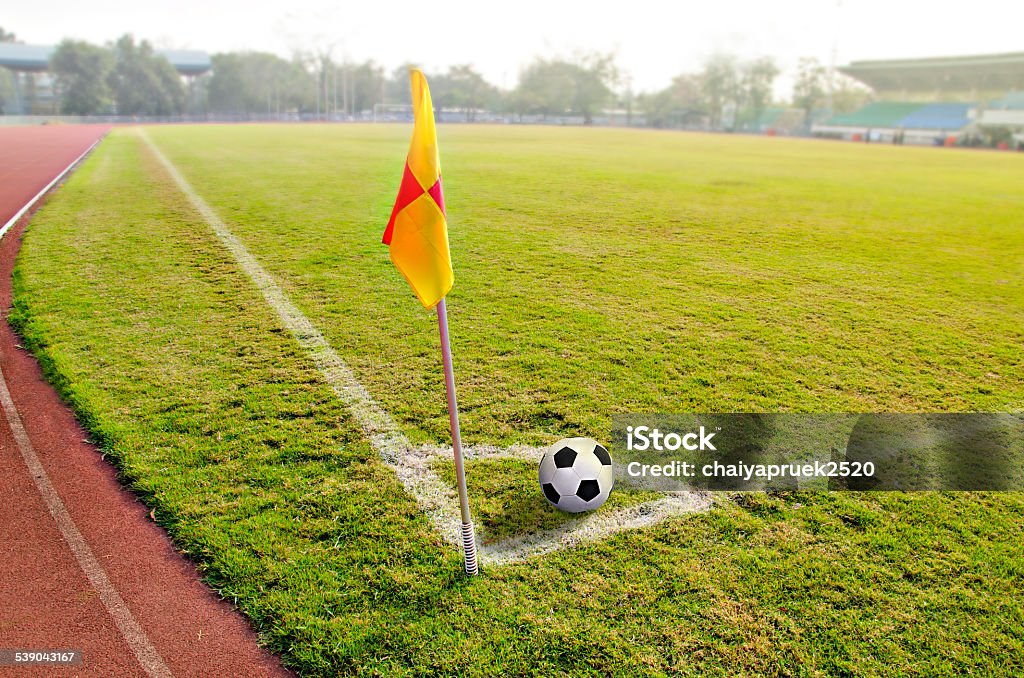 Corner flag with ball on a soccer field 'at' Symbol Stock Photo