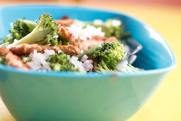Blue bowl filled with fresh rice and vegetable