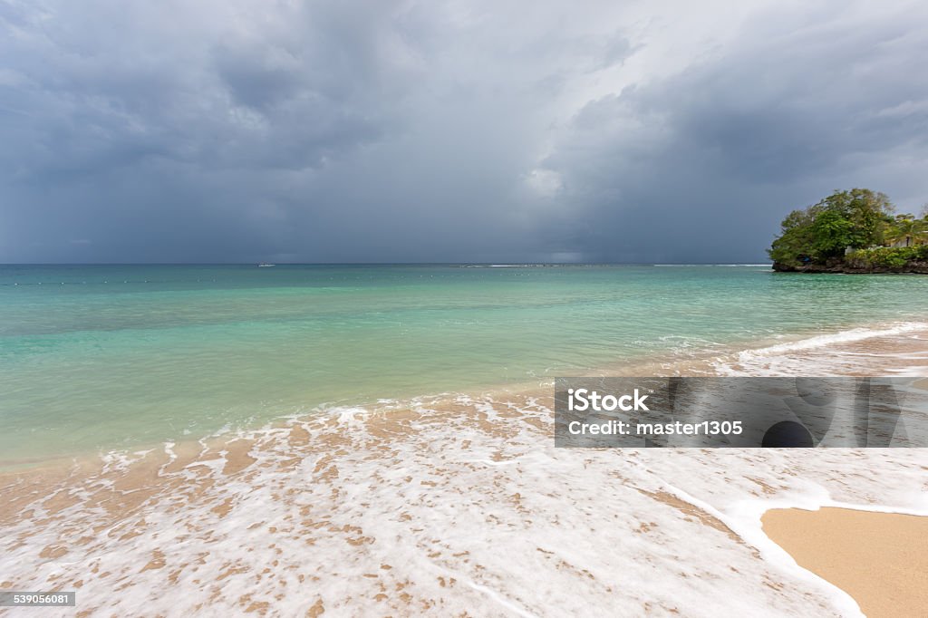 Beach on tropical island. Clear blue water, sand, clouds Beach on the tropical island. Clear blue water, sand and clouds. Beautiful vacation spot. 2015 Stock Photo