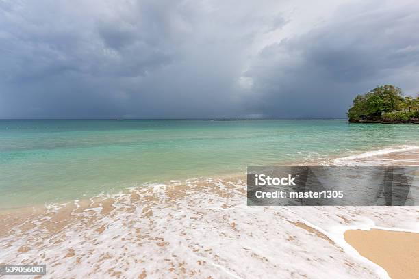 Beach On Tropical Island Clear Blue Water Sand Clouds Stock Photo - Download Image Now