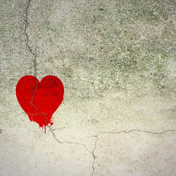 istock Cracked red heart on concrete wall 539057221