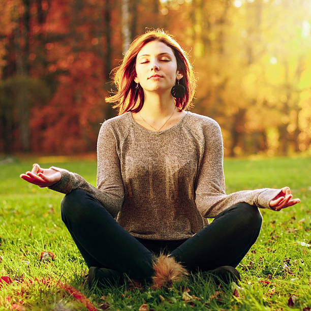 istock Beautiful young girl meditating 539069701