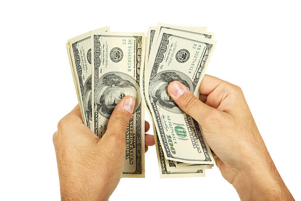 istock Men hand holding hundred dollars bill on white background 539070265