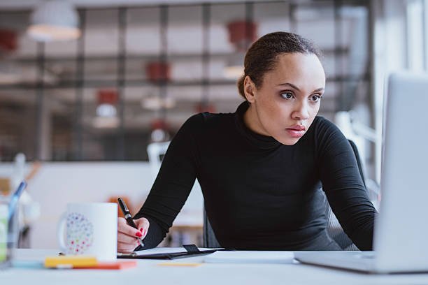 istock Busy young woman working at her desk 539070971