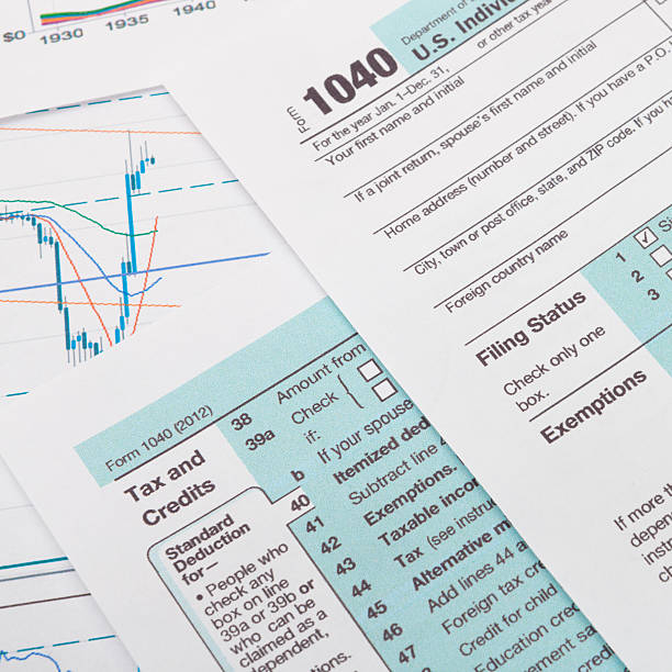 istock US 1040 Tax Form with some financial documets around 539071129