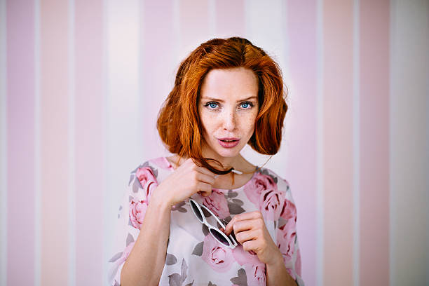 istock Young Woman In Pink Looks Directly At Camera 539072333