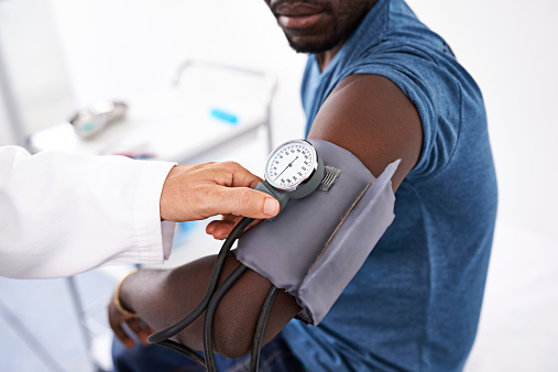 Cropped shot of a doctor measuring a patient's blood pressure
