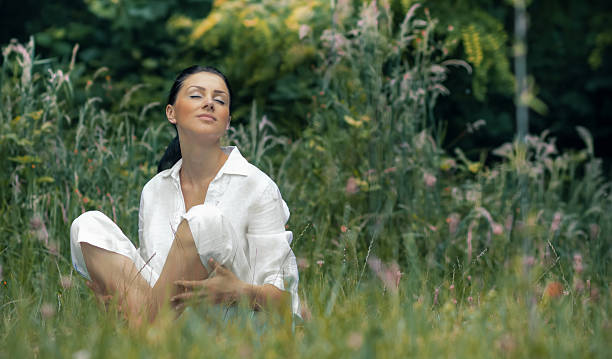 istock Young relaxing woman sitting in the grass 539080521