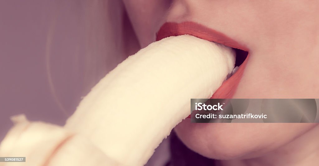 Woman eating banana Woman eating banana, lips close up Eating Stock Photo
