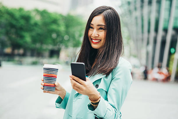 istock Japanese girl with phone and coffee 539085184