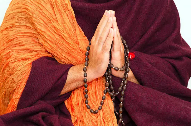 Buddhist Monk hands with mala beads, concept for meditation or pray