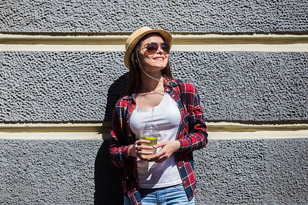 istock Girl drink lemonade against  house wall 539086420