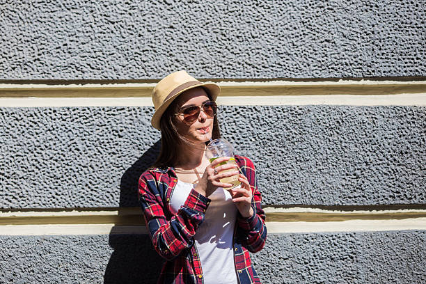 istock Girl drink lemonade against  house wall 539086696