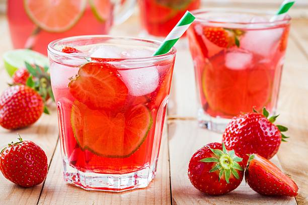 istock Strawberry lemonade with lime and ice in a glass 539087356