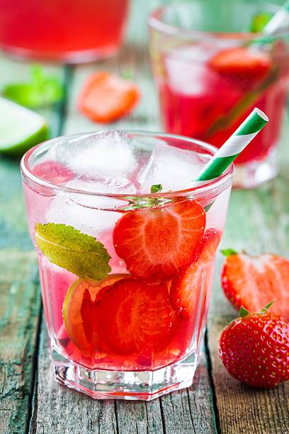 istock Strawberry lemonade with lime and ice in a glass 539087392
