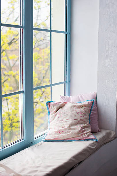 istock Two pillows airing on window sill in room 539088534