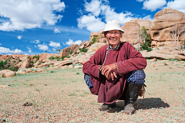 Old Mongolian man in national clothing, rocks on the background Central Mongolia.http://bem.2be.pl/IS/mongolia_380.jpg