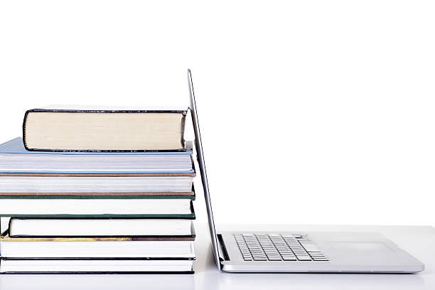 istock Open laptop screen leaning against a stack of books 539090192