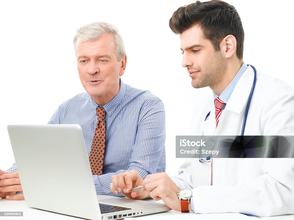 Male doctor and his patient Handsome young doctor explaining results to a senior patient. Isolated on white background 2015 Stock Photo