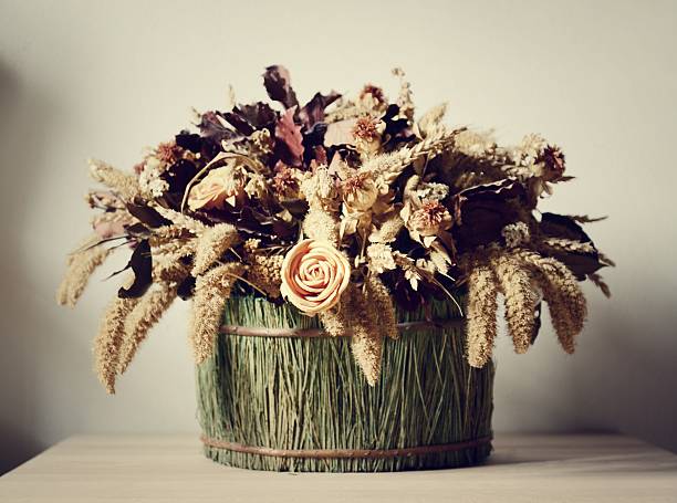 Dried red roses in a wicker basket.