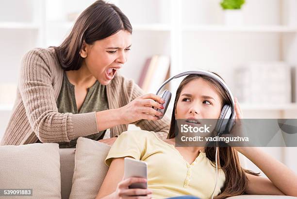 Mother And Daughter Stock Photo - Download Image Now - Adolescence, Discussion, Headphones