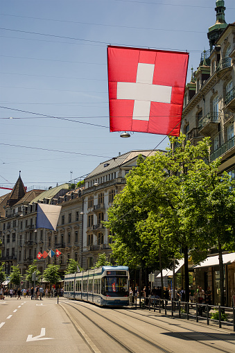 June 2016, streets of Zurich (Switzerland) and a Swiss flag and a flag of Zurich