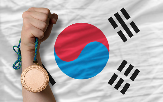 Holding bronze medal for sport and national flag of south korea